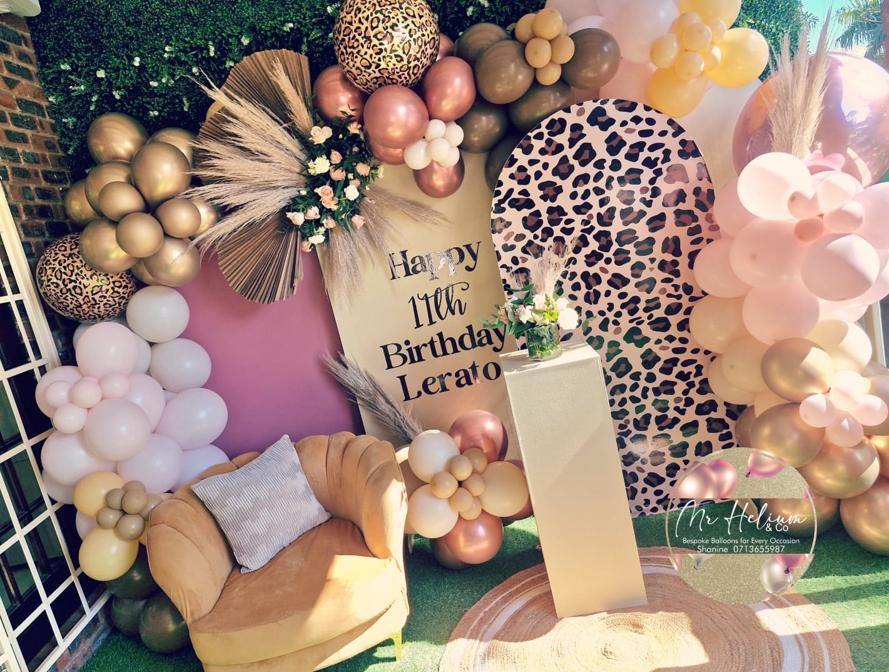 Leopard-print arch backdrop with rose gold, blush and chrome gold balloon garland, pampas grass, florals and a personalised 11th birthday sign