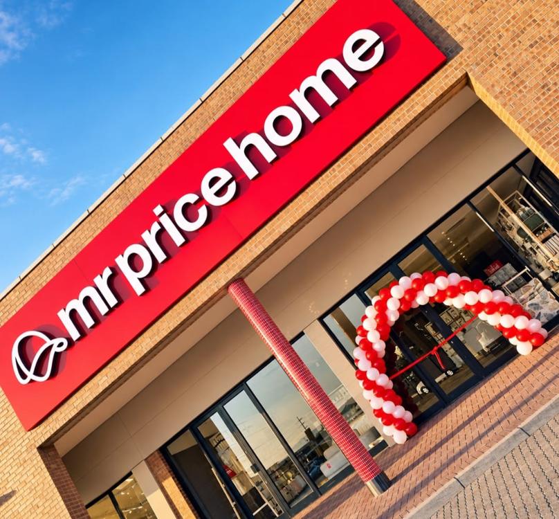 Red and white balloon entrance arch and spiral column at the doors of a national homeware retailer on opening day